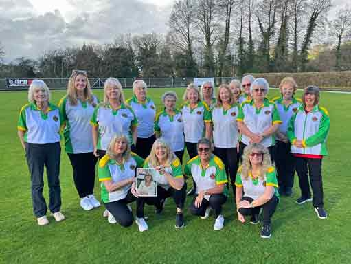Ladies A team posing for team photo on green
