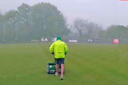 mowing green on a misty morning