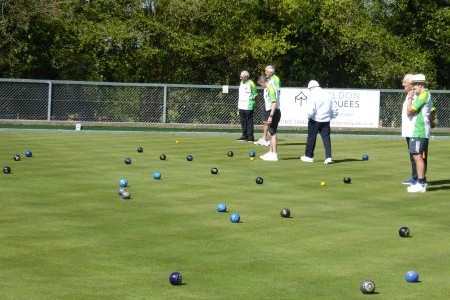 bowlers on the green with bowls ansd jacks visible